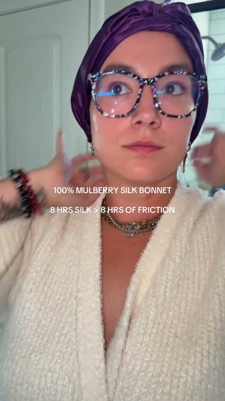 Creator @laurentokk adjusting a purple Blissy silk bonnet in a bathroom mirror
